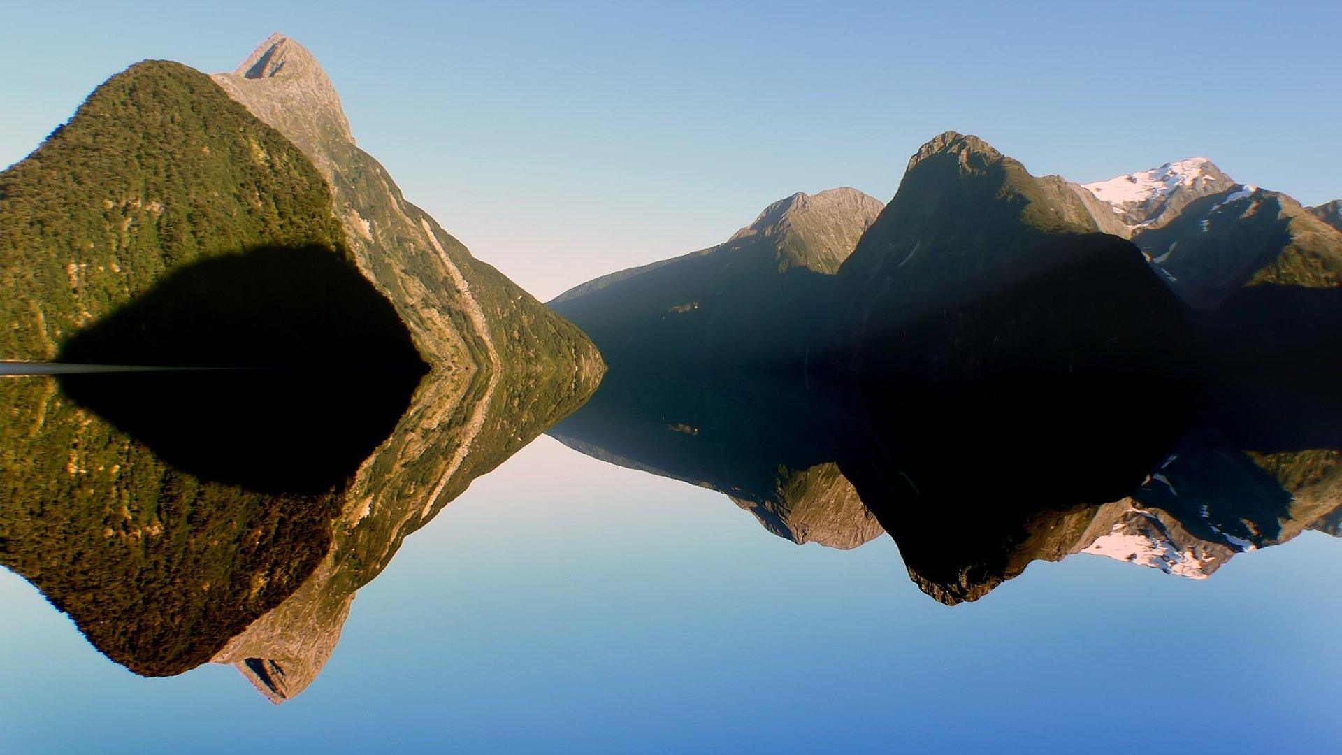 Mitre Peak and the mountains of Milford Sound reflected in still water